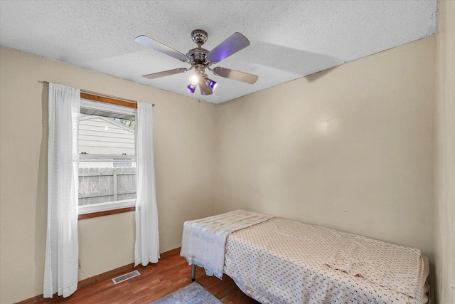 3310 Saratoga Dr, Champaign, IL 61821 - bedroom with wood finished floors, baseboards, a ceiling fan, and a textured ceiling