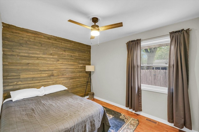3310 Saratoga Dr, Champaign, IL 61821 - bedroom with wood finished floors, baseboards, ceiling fan, and wooden walls