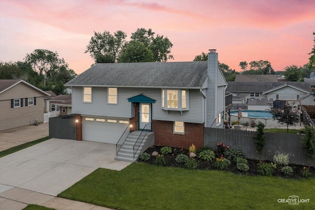 712 Cascade Ave, Romeoville, IL 60446 - bi-level home featuring brick siding, a chimney, concrete driveway, and a garage