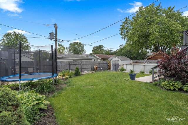 712 Cascade Ave, Romeoville, IL 60446 - fenced backyard with a trampoline and a storage unit
