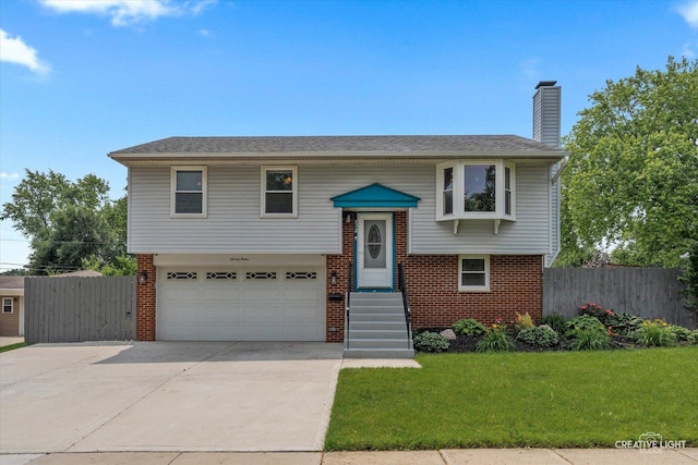 712 Cascade Ave, Romeoville, IL 60446 - bi-level home with an attached garage, brick siding, driveway, and a chimney