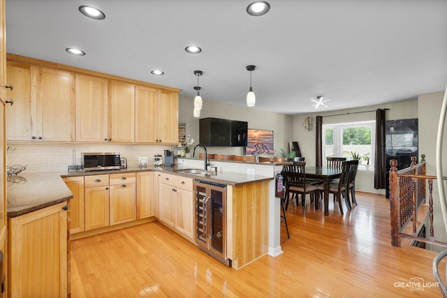 712 Cascade Ave, Romeoville, IL 60446 - kitchen with wine cooler, light brown cabinets, stainless steel microwave, a peninsula, and recessed lighting