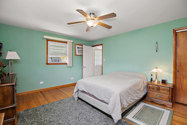 16028 Laramie Ave, Oak Forest, IL 60452 - bedroom with wood finished floors, baseboards, ceiling fan, and an AC wall unit