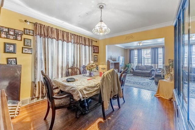 1909 Harvey Ave, Berwyn, IL 60402 - dining space with wood finished floors, a chandelier, and crown molding
