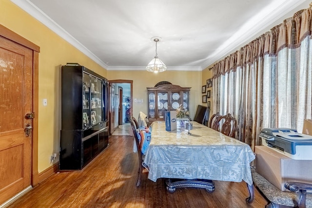1909 Harvey Ave, Berwyn, IL 60402 - dining space with wood finished floors, crown molding, and baseboards