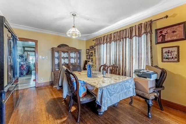 1909 Harvey Ave, Berwyn, IL 60402 - dining space with wood finished floors, baseboards, and crown molding