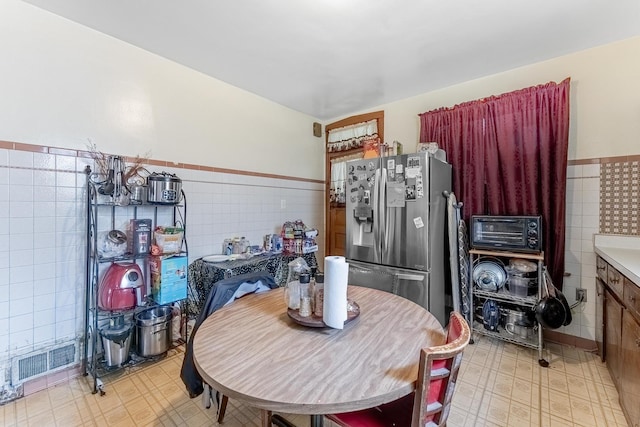1909 Harvey Ave, Berwyn, IL 60402 - dining room featuring tile walls, a wainscoted wall, and light floors
