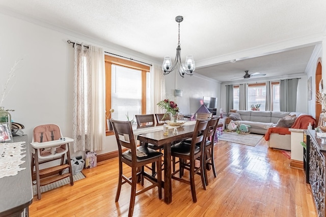 1909 Harvey Ave, Berwyn, IL 60402 - dining space featuring crown molding, light wood-style floors, a chandelier, a ceiling fan, and a textured ceiling