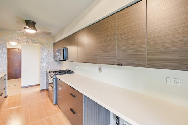 1S150 Spring Rd Unit 5F, Oakbrook Terrace, IL 60181 - kitchen featuring double oven range, wallpapered walls, a ceiling fan, light countertops, and modern cabinets