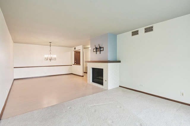 1S150 Spring Rd Unit 5F, Oakbrook Terrace, IL 60181 - unfurnished living room featuring a fireplace, carpet flooring, a chandelier, and baseboards