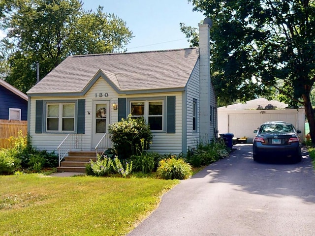 130 Syril Dr, Geneva, IL 60134 - view of front of home featuring a chimney, roof with shingles, and entry steps