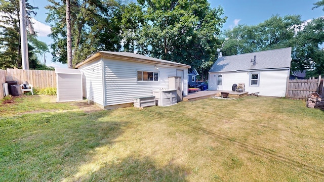 130 Syril Dr, Geneva, IL 60134 - back of property featuring a fenced backyard, an outbuilding, and a deck