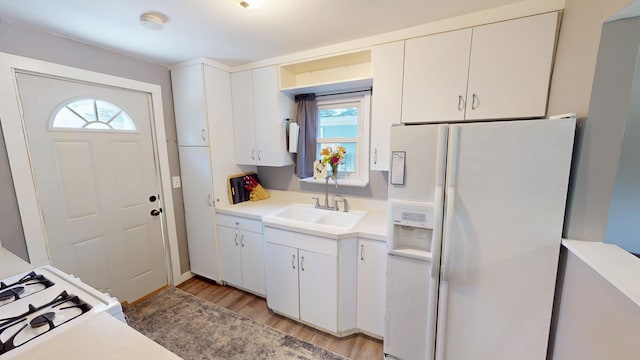 130 Syril Dr, Geneva, IL 60134 - kitchen with white appliances, light wood-type flooring, light countertops, and white cabinetry