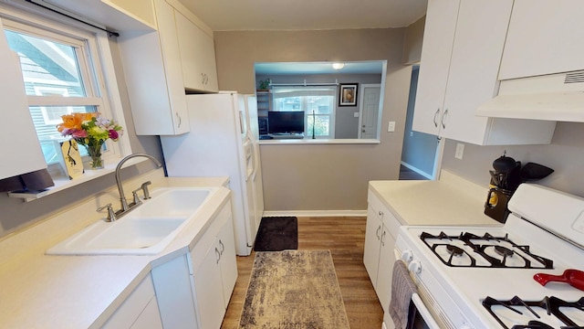 130 Syril Dr, Geneva, IL 60134 - kitchen featuring white appliances, ventilation hood, light countertops, and healthy amount of natural light