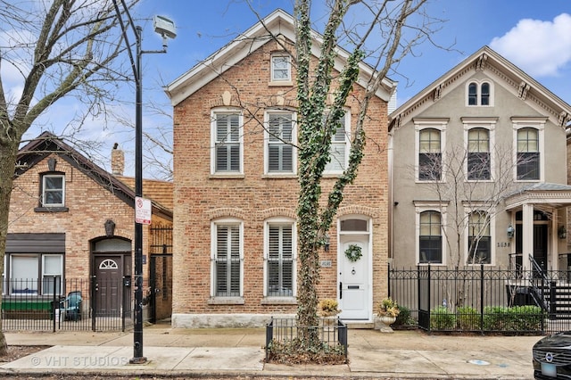 1636 N Cleveland Ave, Chicago, IL 60614 - view of front of home with brick siding and a fenced front yard