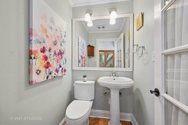 1636 N Cleveland Ave, Chicago, IL 60614 - half bathroom with ornamental molding, toilet, wood finished floors, and baseboards