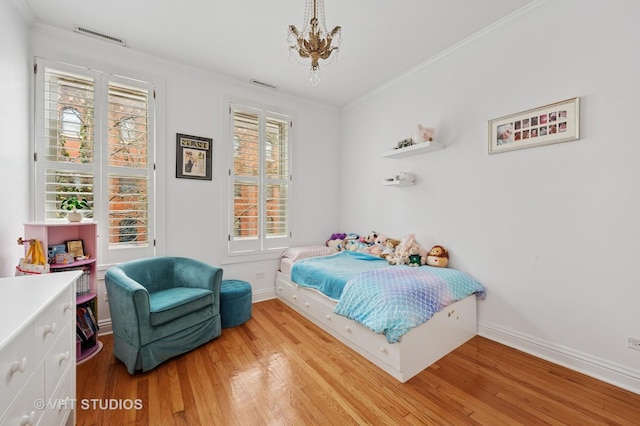 1636 N Cleveland Ave, Chicago, IL 60614 - bedroom with light wood finished floors, crown molding, a chandelier, and baseboards