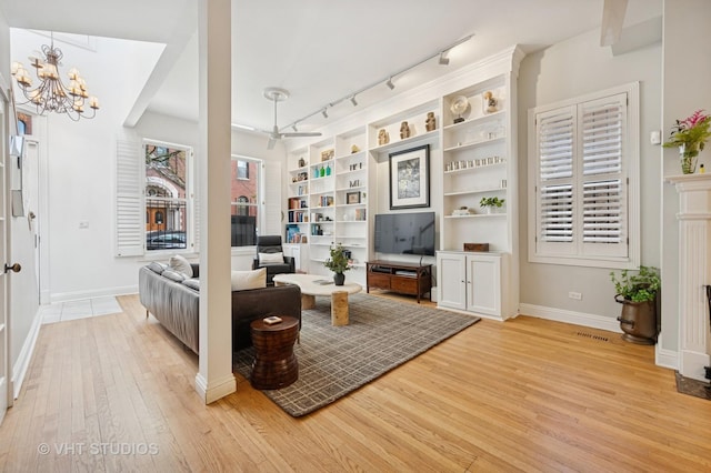 1636 N Cleveland Ave, Chicago, IL 60614 - living room with light wood finished floors, a chandelier, rail lighting, and baseboards