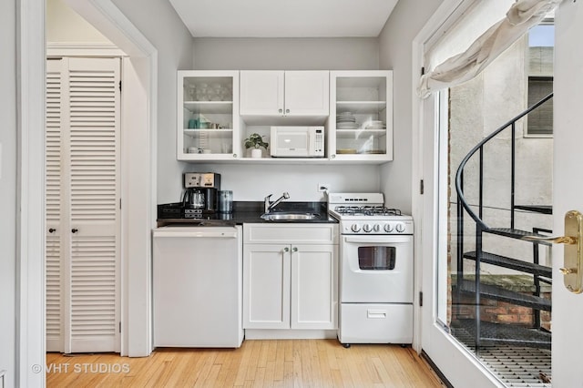 1636 N Cleveland Ave, Chicago, IL 60614 - kitchen with white appliances, a sink, white cabinetry, light wood-style floors, and glass insert cabinets