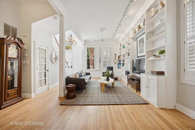 1636 N Cleveland Ave, Chicago, IL 60614 - living room with track lighting, light wood finished floors, baseboards, and built in shelves