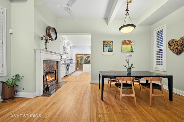 1636 N Cleveland Ave, Chicago, IL 60614 - dining room featuring light wood-type flooring, beam ceiling, baseboards, and a high end fireplace