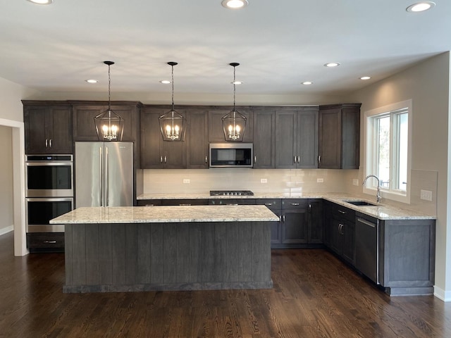 2019 Middleton Ave, Lisle, IL 60532 - kitchen with appliances with stainless steel finishes, a sink, a center island, decorative backsplash, and light stone countertops