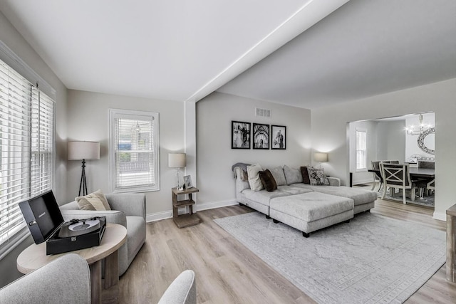 529 Circle Ave, Forest Park, IL 60130 - living area with a chandelier, wood finished floors, and baseboards