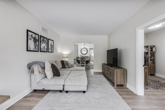 529 Circle Ave, Forest Park, IL 60130 - living room with wood finished floors, baseboards, and a chandelier