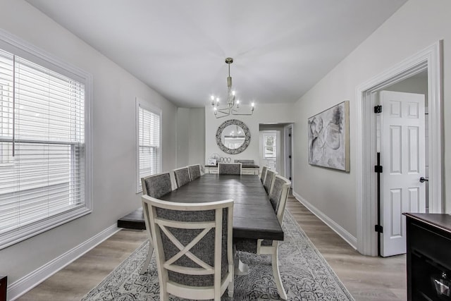 529 Circle Ave, Forest Park, IL 60130 - dining area with a chandelier, light wood finished floors, and baseboards