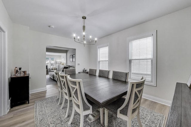 529 Circle Ave, Forest Park, IL 60130 - dining area featuring a chandelier, light wood-style flooring, and baseboards