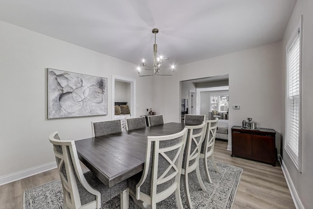 529 Circle Ave, Forest Park, IL 60130 - dining room with a chandelier, light wood finished floors, and baseboards