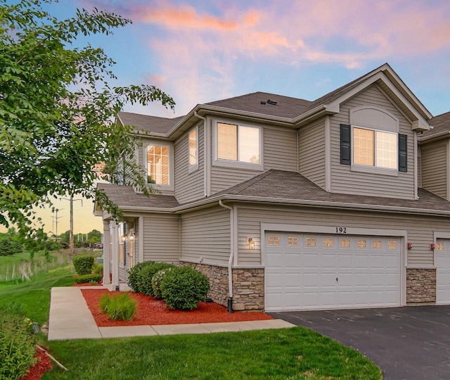 192 Owen St, Matteson, IL 60443 - view of property featuring a garage, asphalt driveway, and stone siding