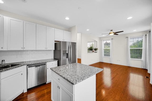 192 Owen St, Matteson, IL 60443 - kitchen with stainless steel appliances, ceiling fan, dark wood-style floors, backsplash, and a center island