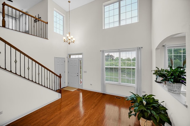 192 Owen St, Matteson, IL 60443 - entryway with wood finished floors, a towering ceiling, stairs, plenty of natural light, and a chandelier