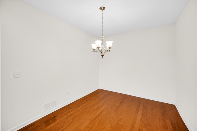 192 Owen St, Matteson, IL 60443 - spare room featuring baseboards, wood finished floors, and a chandelier