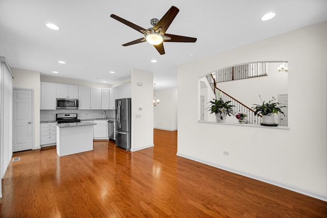 192 Owen St, Matteson, IL 60443 - kitchen featuring appliances with stainless steel finishes, wood finished floors, a ceiling fan, a kitchen island, and recessed lighting