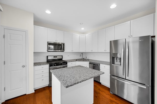192 Owen St, Matteson, IL 60443 - kitchen featuring appliances with stainless steel finishes, a sink, light stone counters, a kitchen island, and white cabinets
