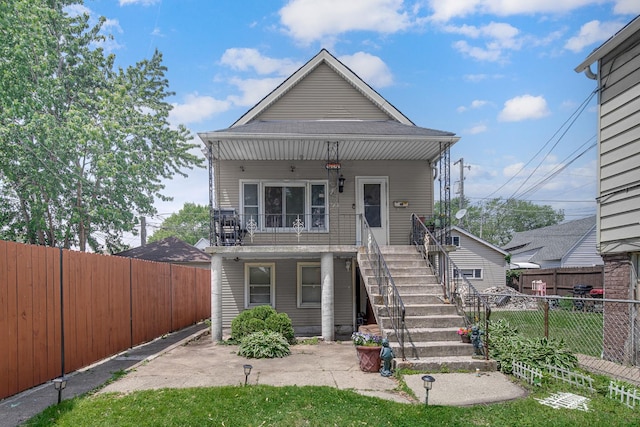 9620 S Exchange Ave, Chicago, IL 60617 - view of front of property featuring stairway, a porch, and a fenced backyard