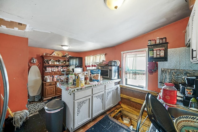9620 S Exchange Ave, Chicago, IL 60617 - kitchen with lofted ceiling, stainless steel microwave, and a center island
