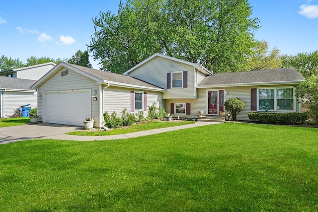 136 Anita Dr, Bourbonnais, IL 60914 - split level home with a garage, concrete driveway, a front lawn, and a shingled roof