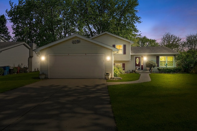 136 Anita Dr, Bourbonnais, IL 60914 - split level home with a garage, concrete driveway, and a lawn