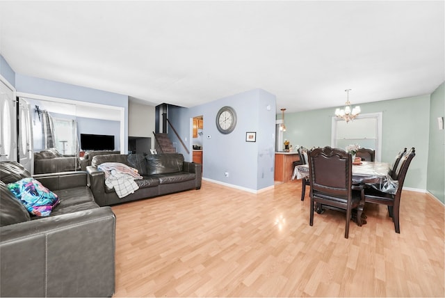 136 Anita Dr, Bourbonnais, IL 60914 - living room featuring light wood-type flooring, a chandelier, stairs, and baseboards