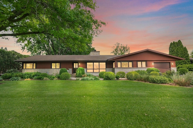 115 Thornbrook Rd, Dekalb, IL 60115 - ranch-style house with a garage, a chimney, a front lawn, and stone siding