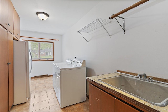 115 Thornbrook Rd, Dekalb, IL 60115 - laundry room featuring washing machine and dryer, cabinet space, and light tile patterned floors