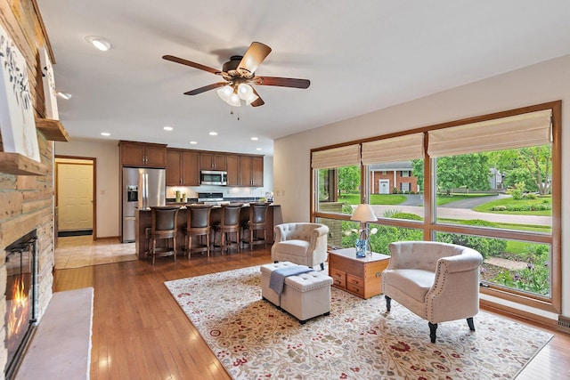 115 Thornbrook Rd, Dekalb, IL 60115 - living area with a ceiling fan, a stone fireplace, light wood finished floors, and recessed lighting
