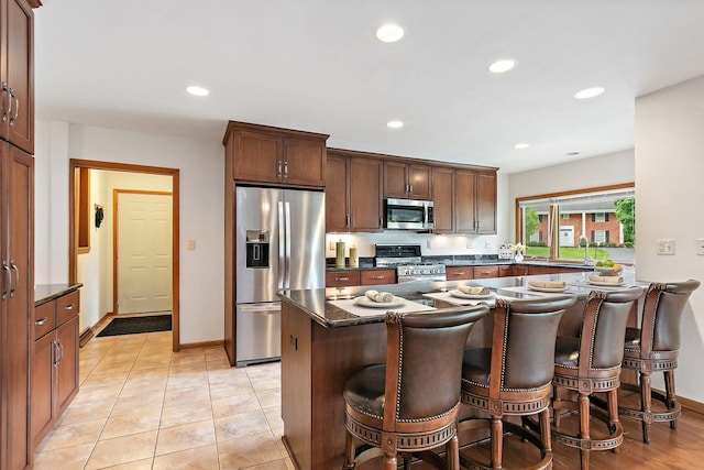 115 Thornbrook Rd, Dekalb, IL 60115 - kitchen with stainless steel appliances, a breakfast bar area, recessed lighting, a sink, and baseboards