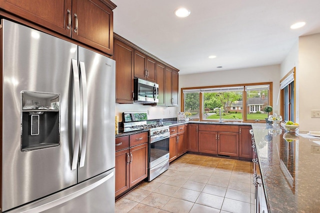 115 Thornbrook Rd, Dekalb, IL 60115 - kitchen with appliances with stainless steel finishes, light tile patterned floors, dark stone countertops, recessed lighting, and a sink