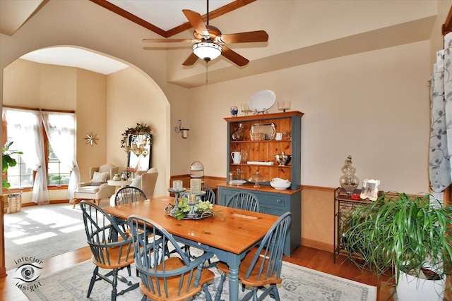 21048 Tall Grass Dr, Mokena, IL 60448 - dining room featuring arched walkways, light wood-style flooring, ceiling fan, and ornamental molding