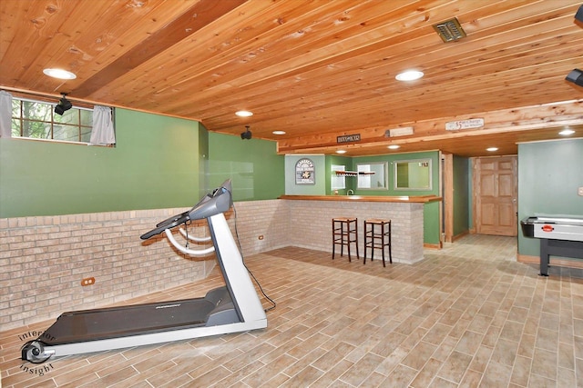 21048 Tall Grass Dr, Mokena, IL 60448 - exercise area featuring wooden ceiling, brick wall, bar, recessed lighting, and a wainscoted wall