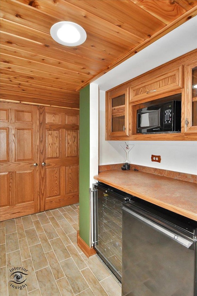 21048 Tall Grass Dr, Mokena, IL 60448 - kitchen featuring wood ceiling, black microwave, beverage cooler, glass insert cabinets, and light countertops